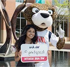 SouthPaw and a USA Student hold a sign that states: 我们是 Accepting